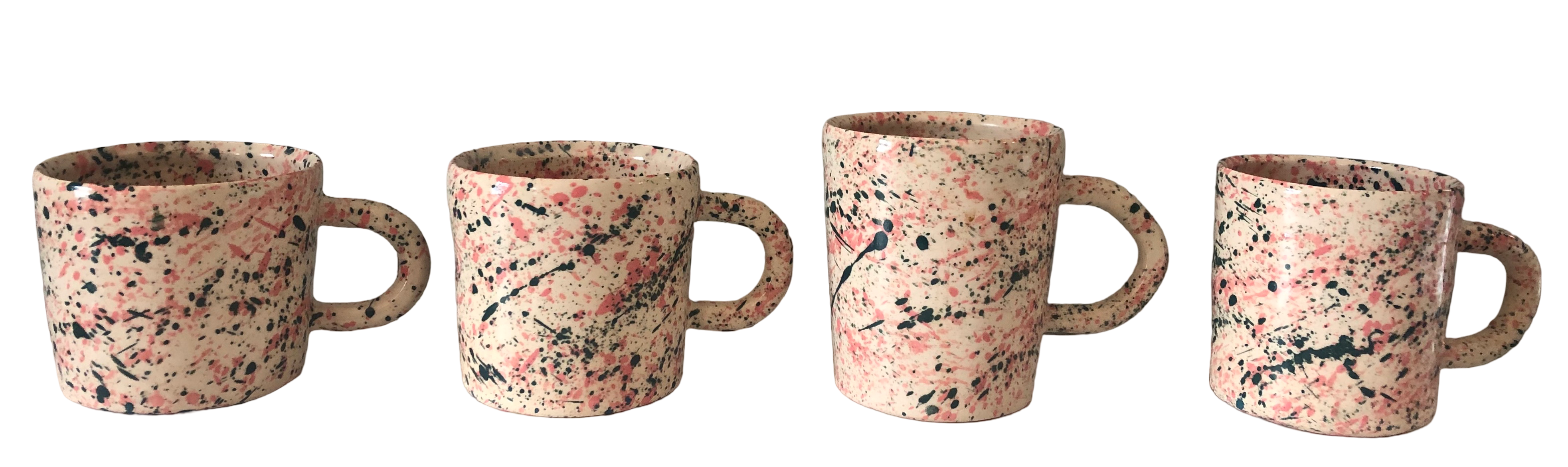 four mugs lined up horizontally. the clay is white and the exterior is splattered with pink and dark blue.